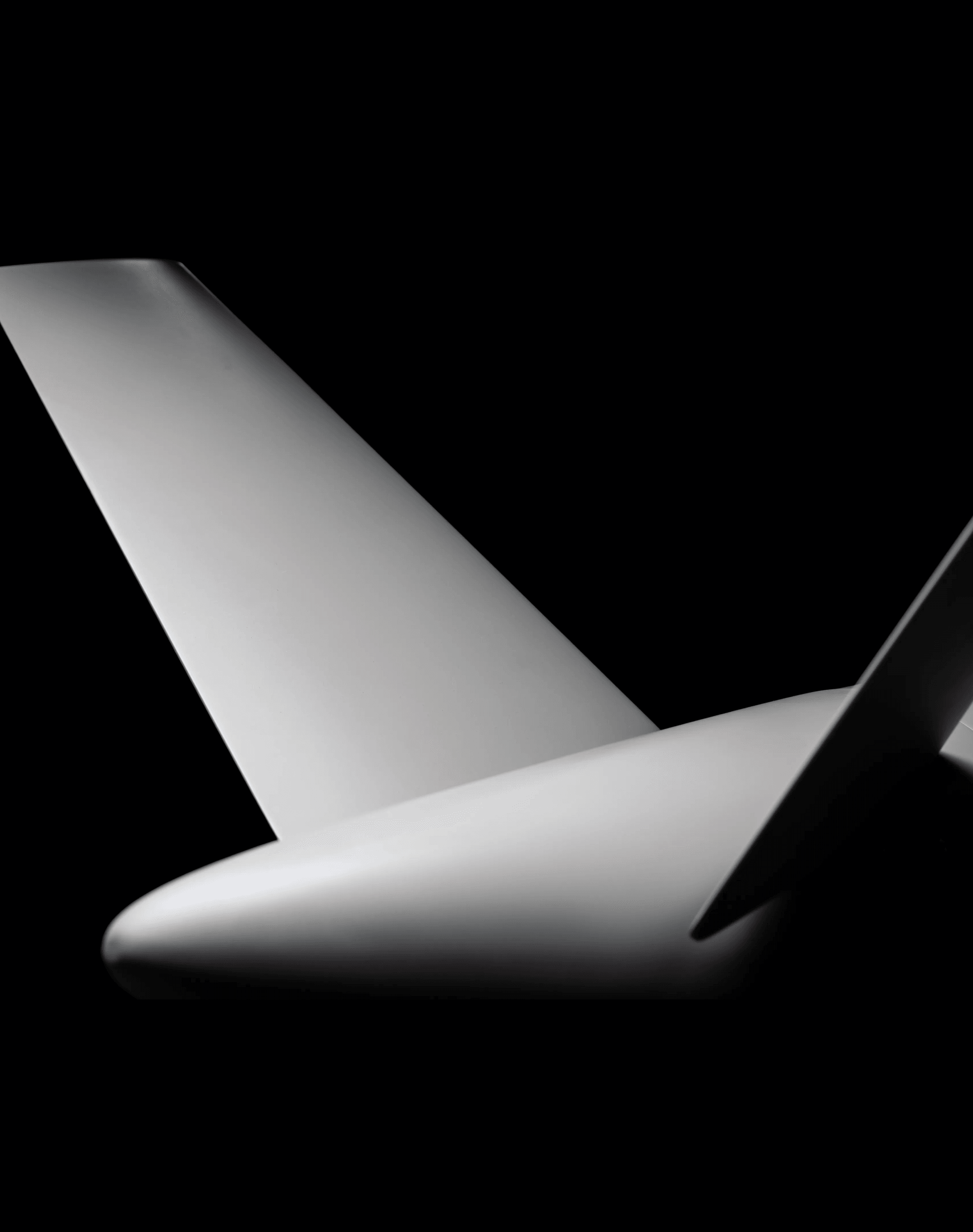 The tail fin and stabiliser of the Covenant airframe, lit from the left against black.